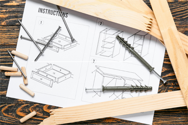 furniture instructions with hardware sitting on top